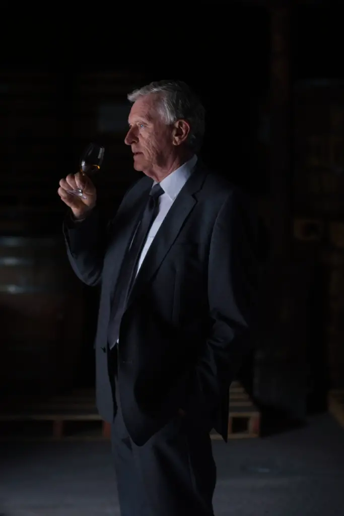 Man drinking a glass of whiskey